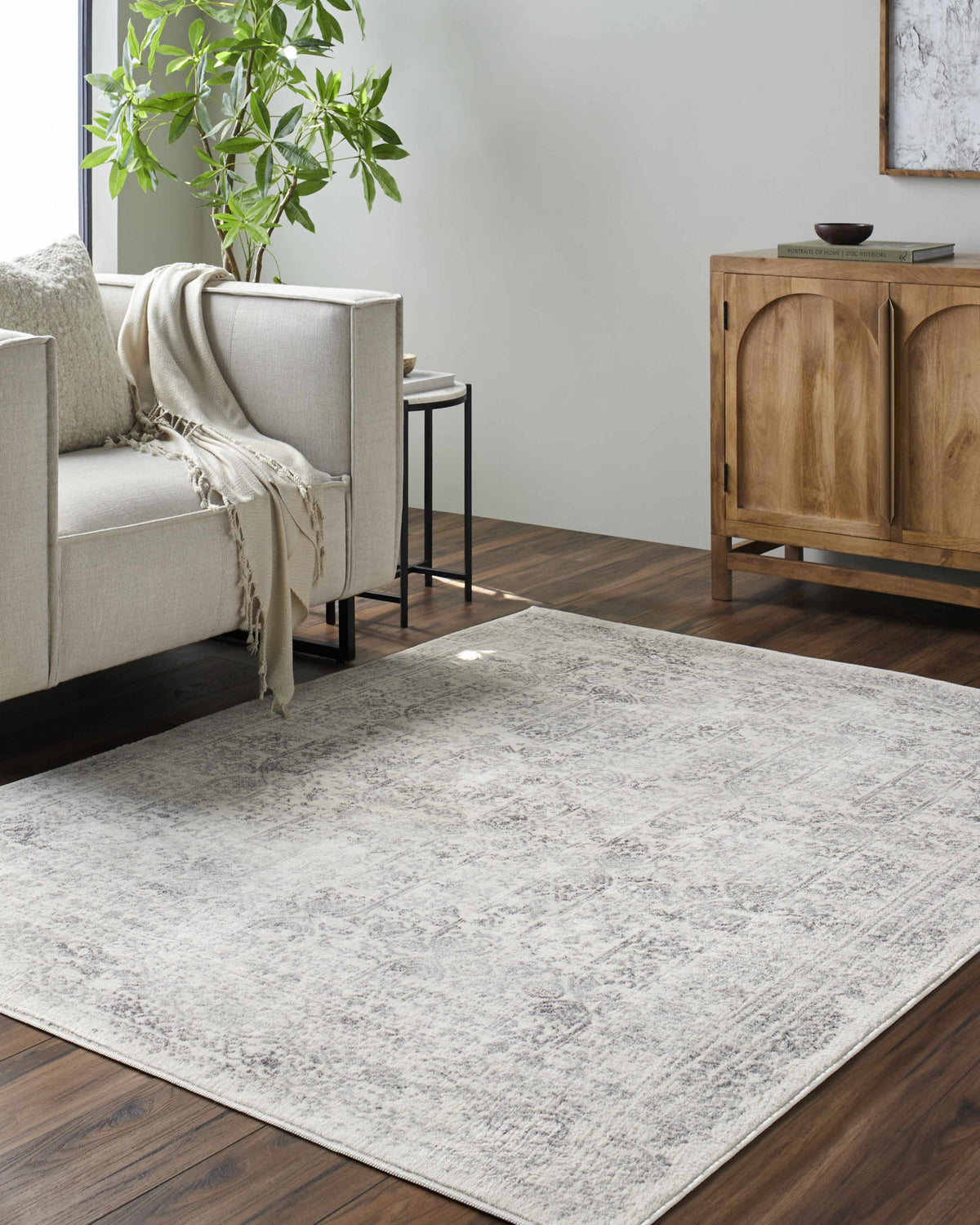 Hauteloom Michie area rug in neutral tones, featuring a modern geometric pattern, placed in a contemporary living room setting.