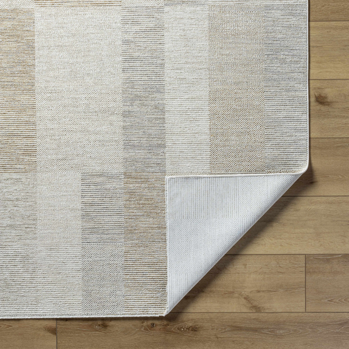 Folded Radia Luxe rug by Boutique Rugs showing soft, textured fabric in neutral tones for a stylish home decor addition.