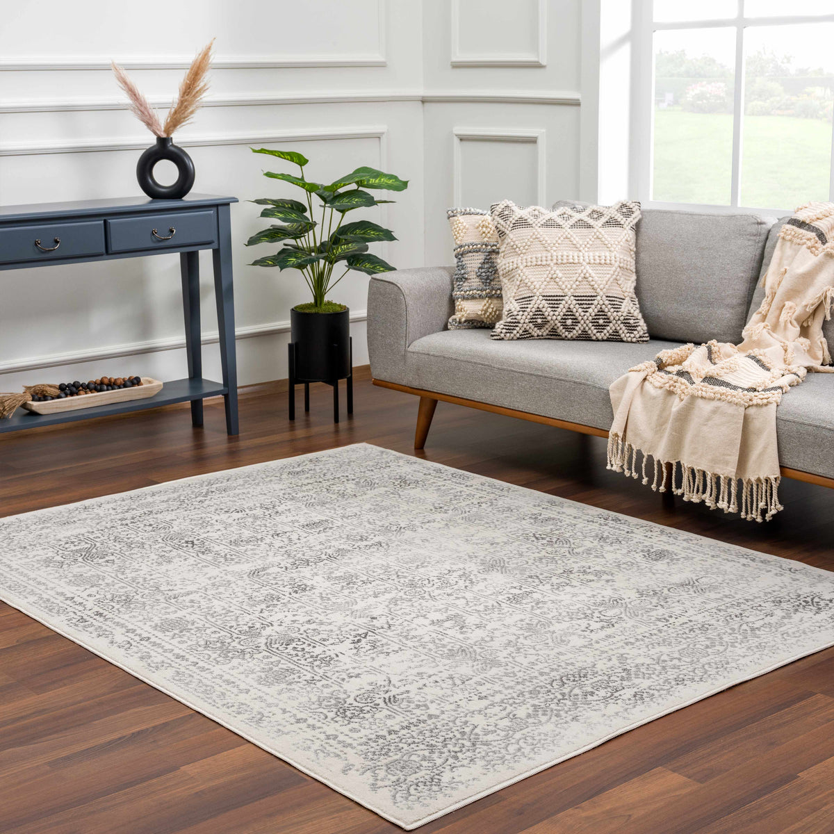 Hauteloom Michie area rug with intricate geometric patterns on a neutral-colored floor in a modern living room scene.