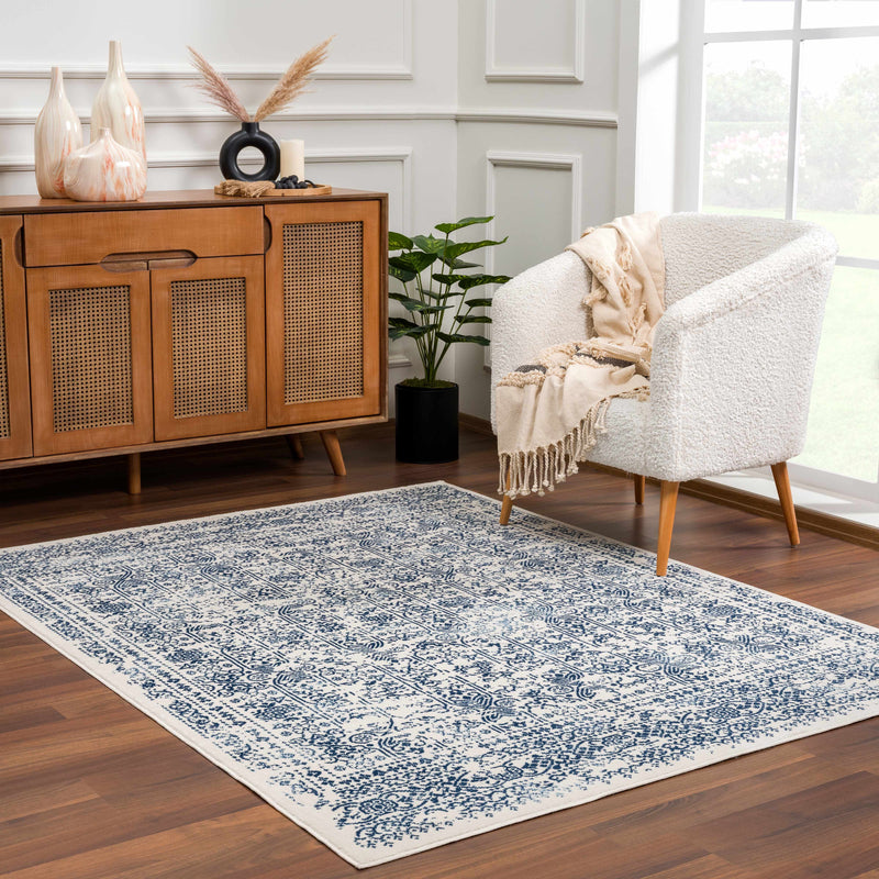 Hauteloom Michie Blue Area Rug spread on hardwood floor in modern living room, featuring vibrant blue pattern and soft texture.