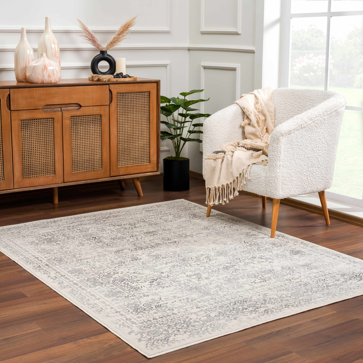 Hauteloom Michie area rug with geometric pattern, plush texture, and neutral tones, placed in a modern living room setting.