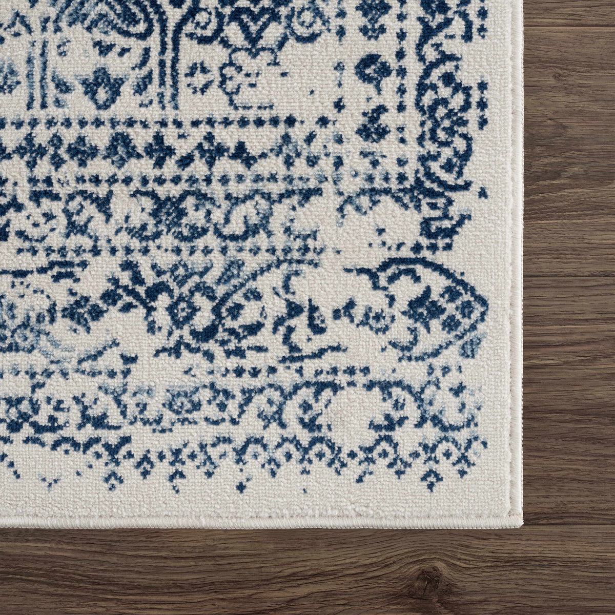 Hauteloom Michie Blue area rug with geometric pattern, shown in the corner of a room for a stylish home decor accent.