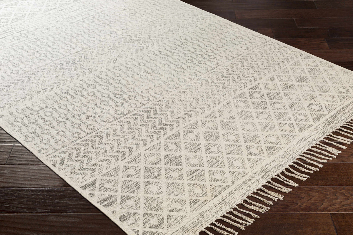 Corner view of Valyermo beige hand-woven cotton rug by Boutique Rugs, showcasing its textured, natural fiber design.