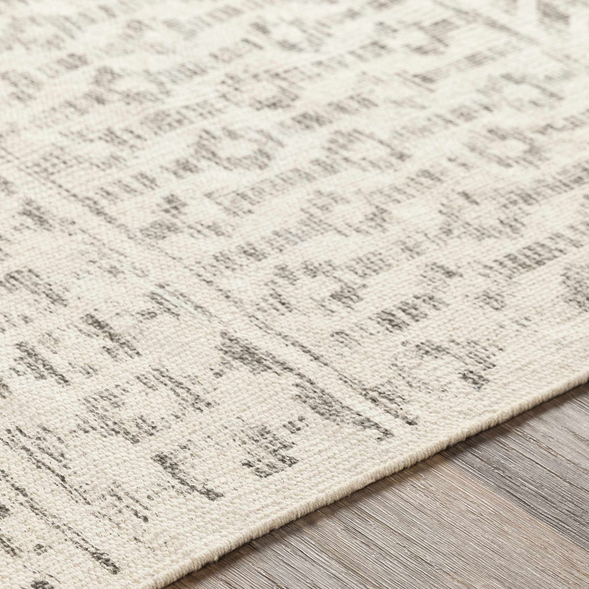 Close-up of the beige Valyermo hand-woven cotton rug by Boutique Rugs, showcasing its textured, natural weave pattern.