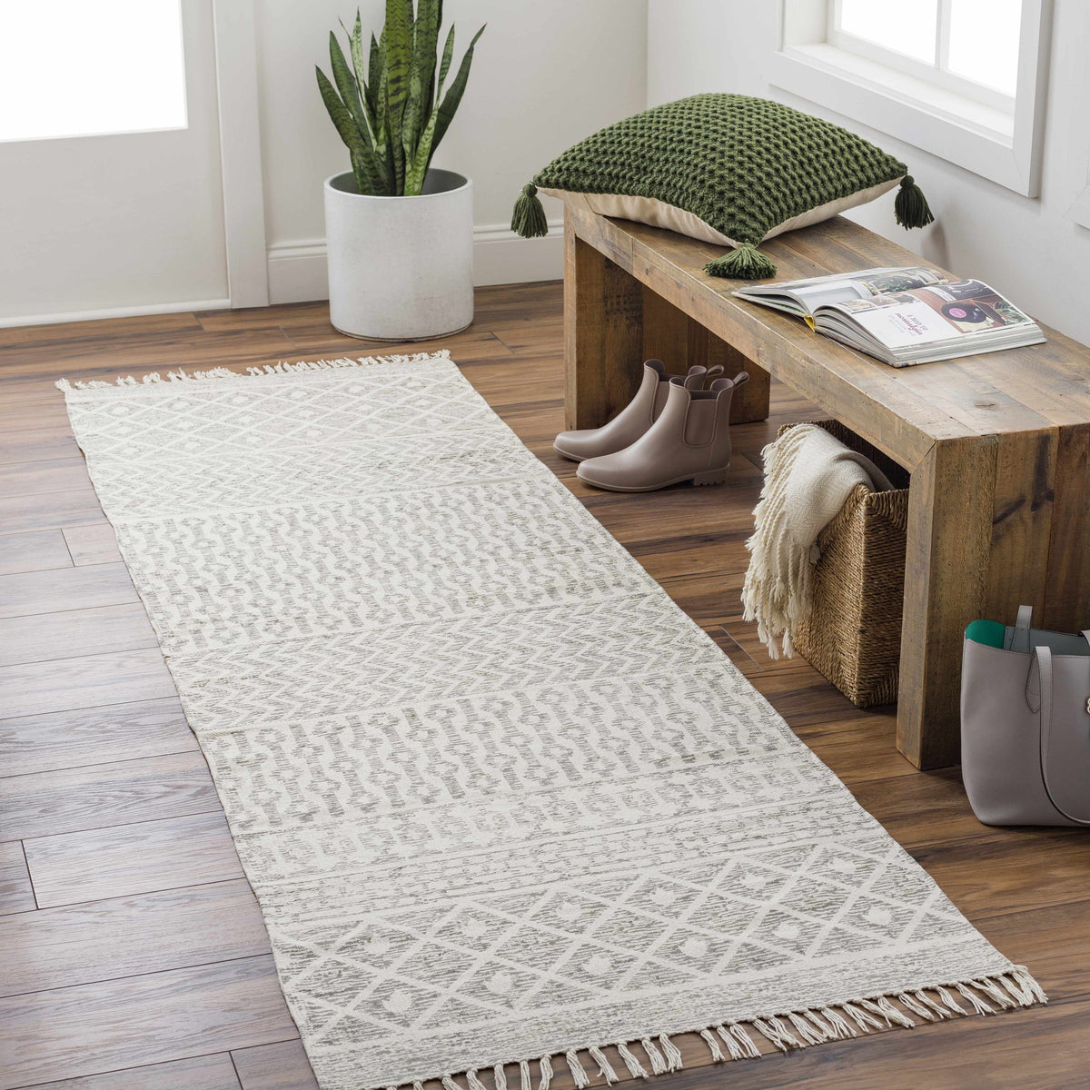 Beige hand-woven cotton rug from Boutique Rugs, styled in a room scene, showcasing soft, textured surface and intricate weaving details.